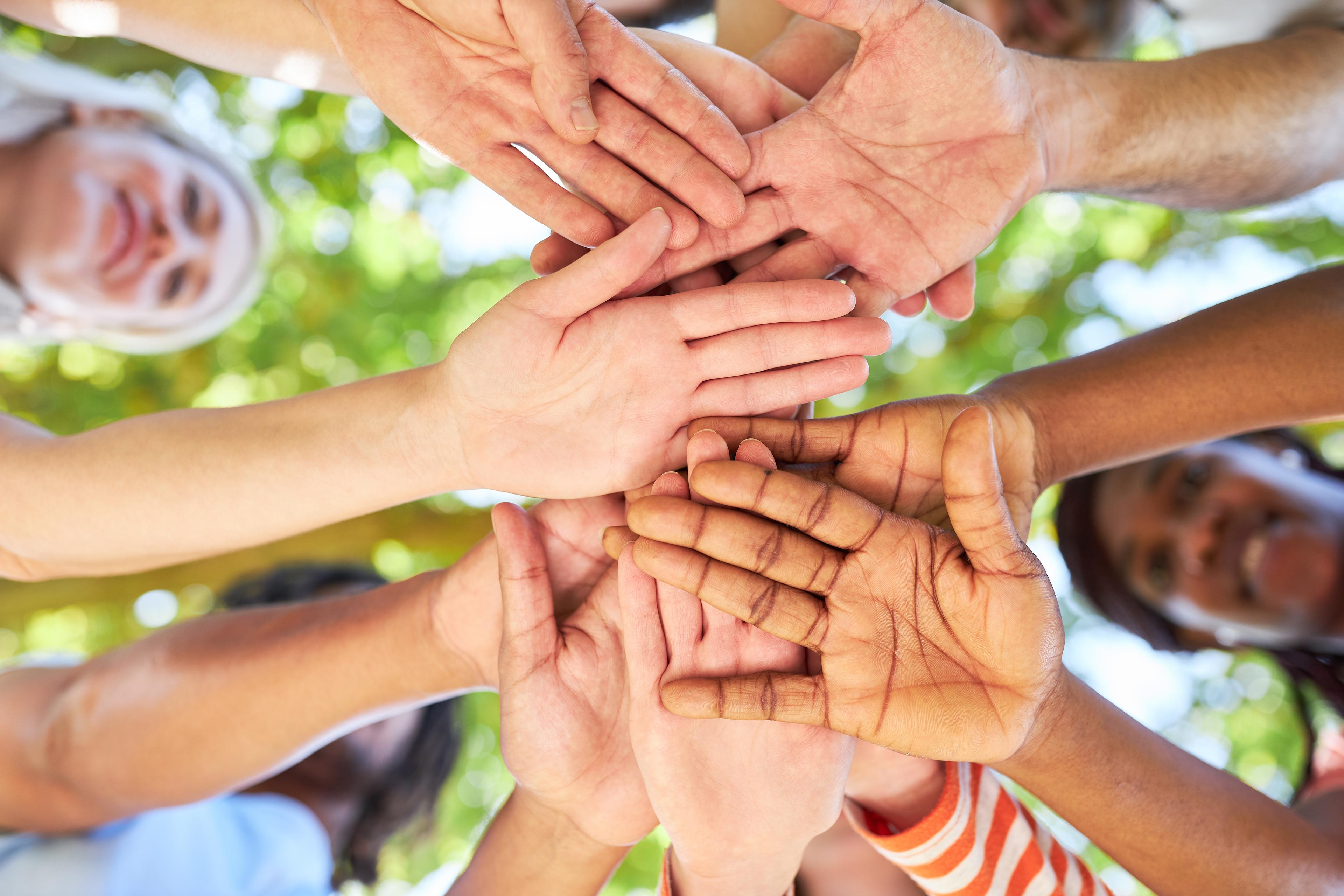 People holding their hands in a circle